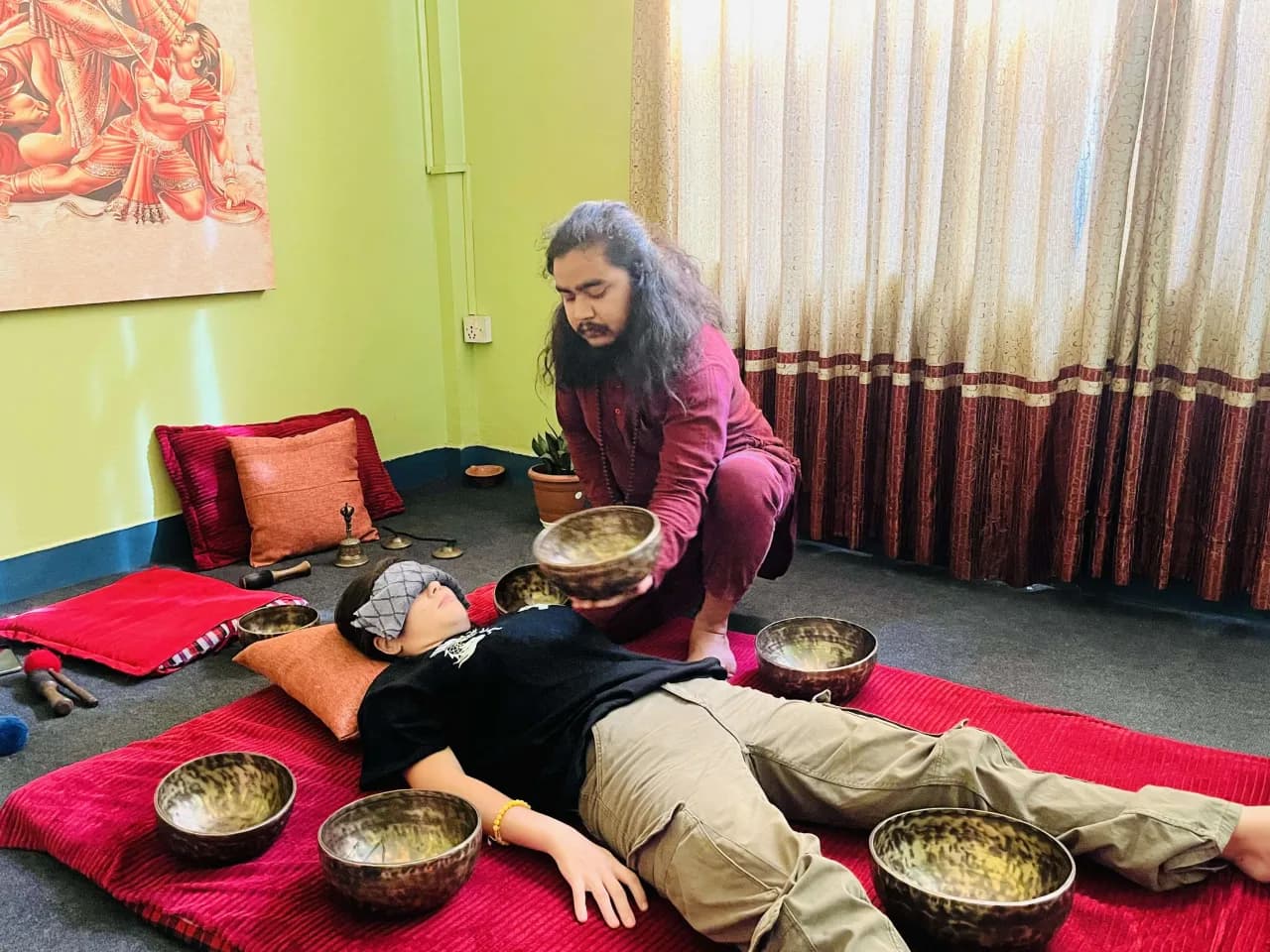 Sound healing practitioner with singing bowls